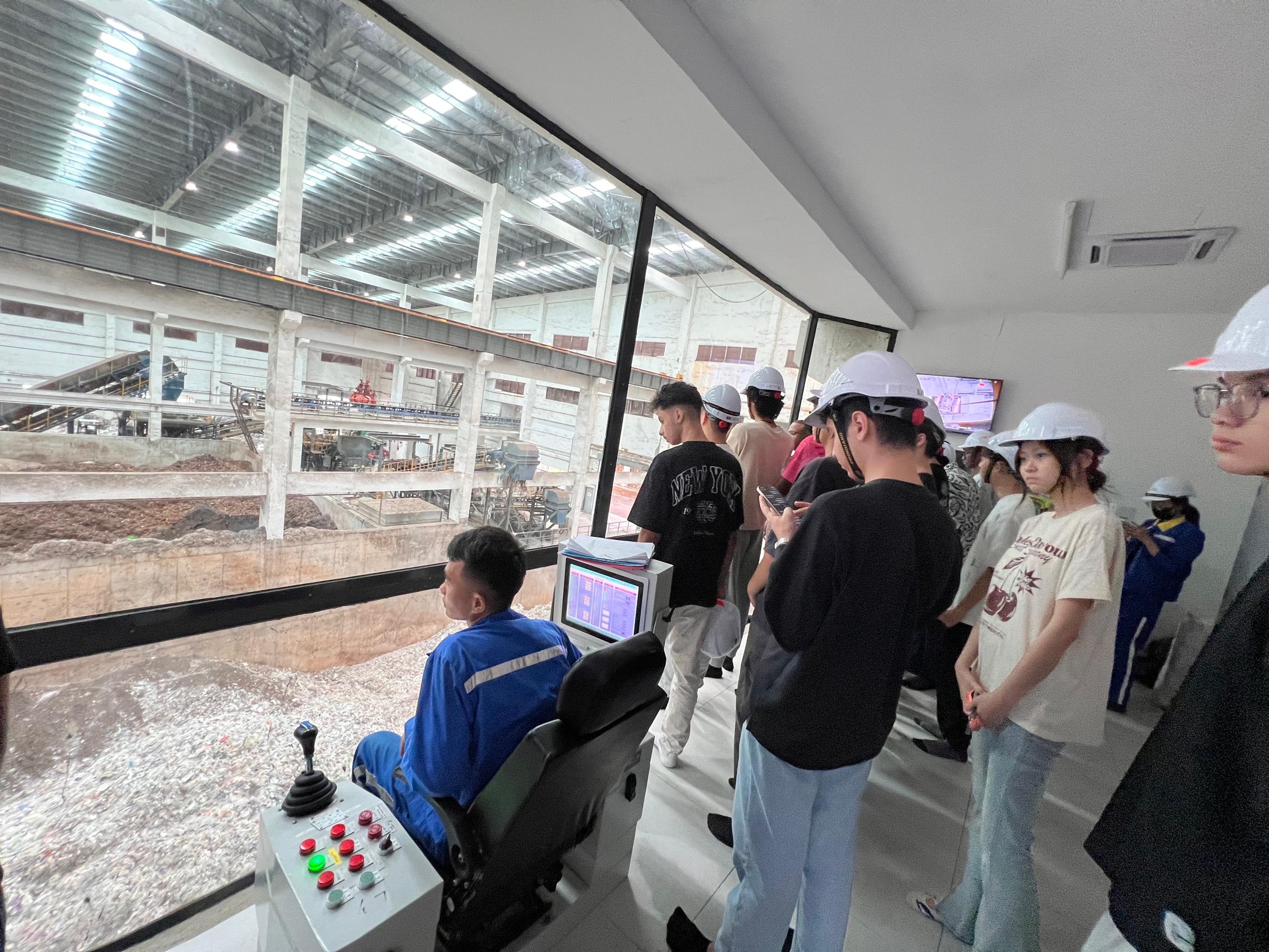 A close-up learning moment as students watch the crane operator at work